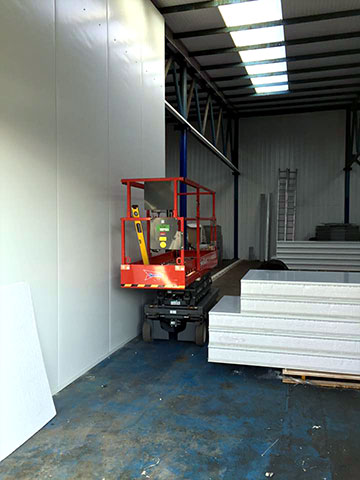 building work in progress using cherry picker machine